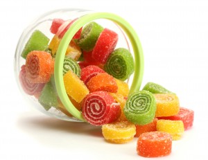 colorful jelly candies in glass jar isolated on white